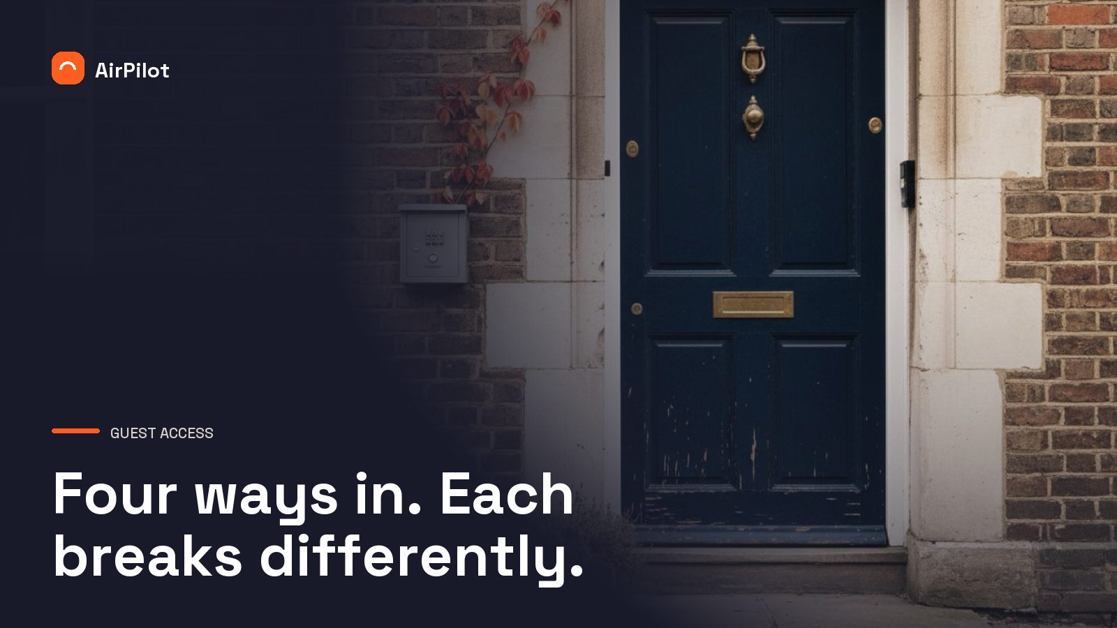 A navy panelled front door on a British brick terrace, with a small grey key safe mounted on the wall beside it